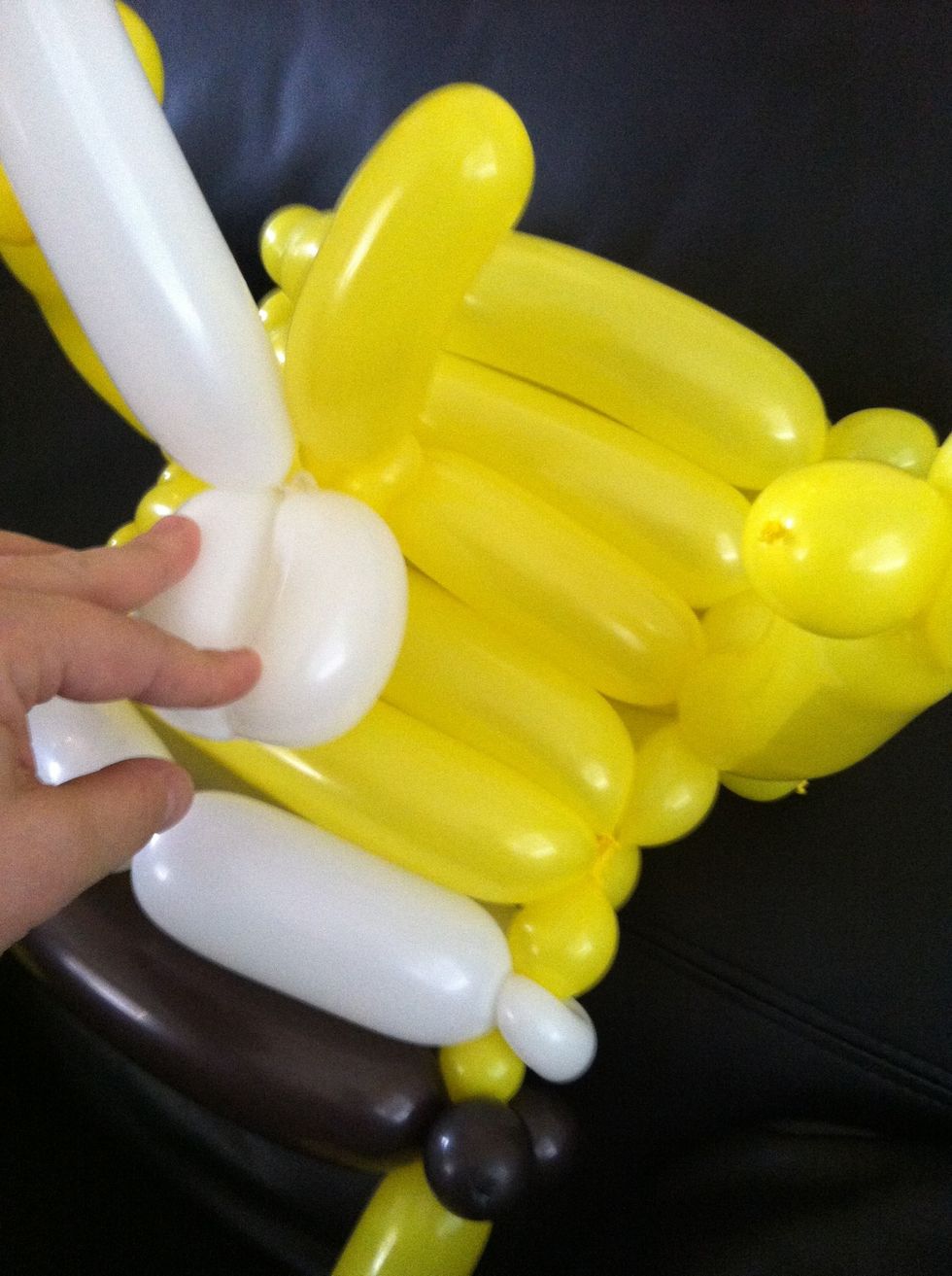 Take white bubbles (these will be teeth) and twist onto nose.