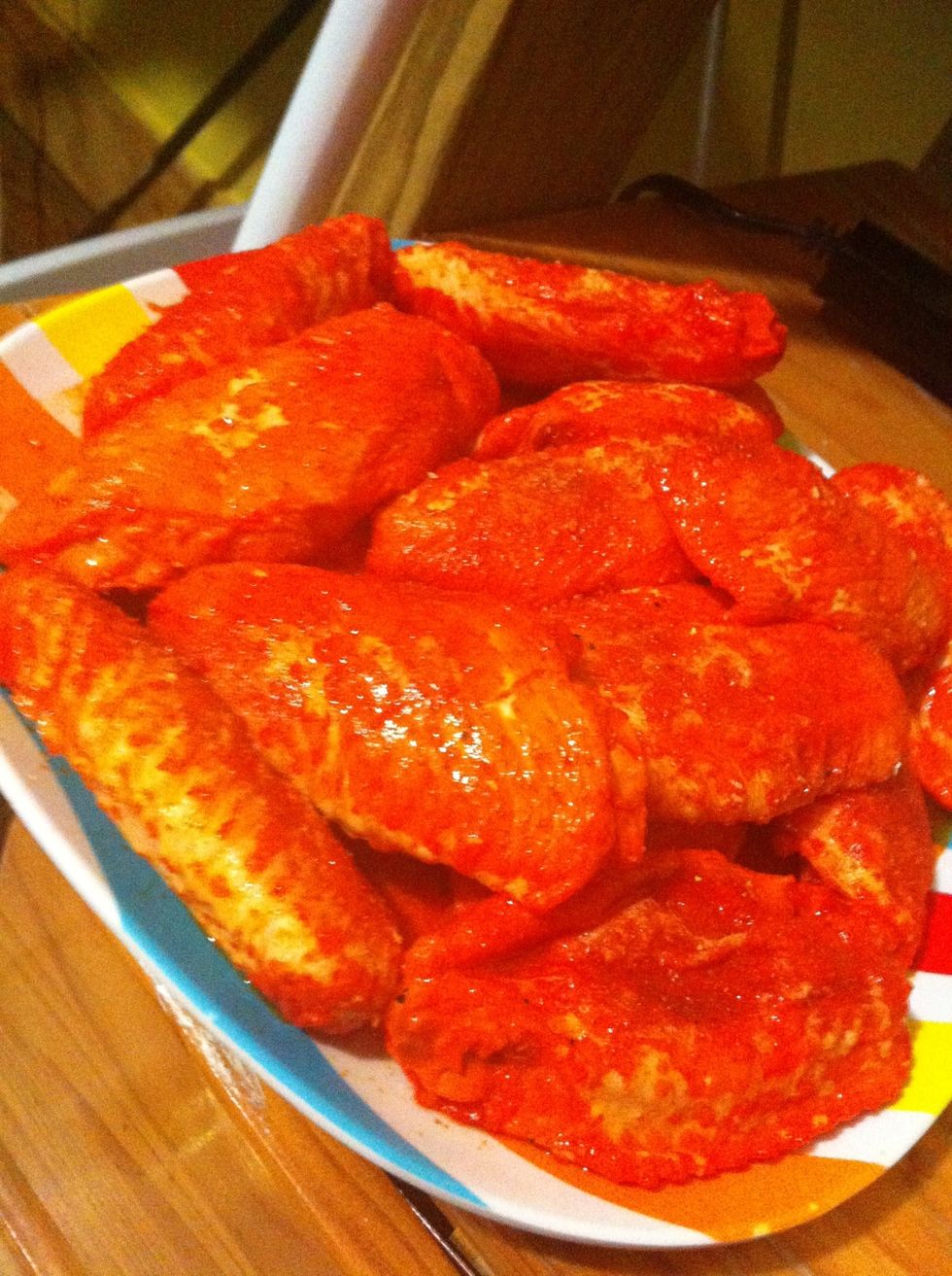 Take wings out of bowl place on plate . This is important to drain some of the liquid out of chicken . Atleast until wings come to room temp. ( you can do this while heating oil)