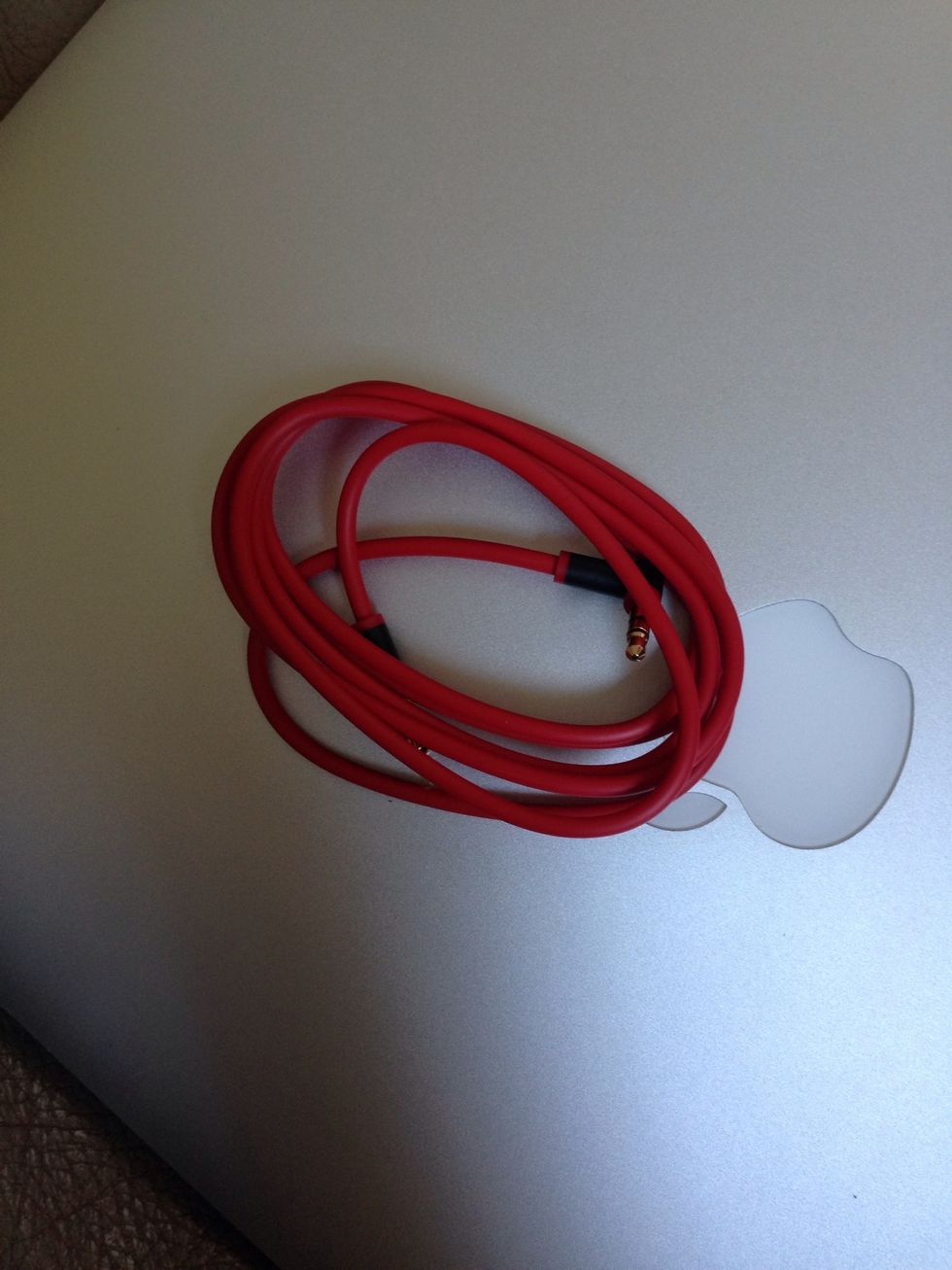 Take you headphone line out of the card stock holder, but leave it in the same shape and don't unravel it.