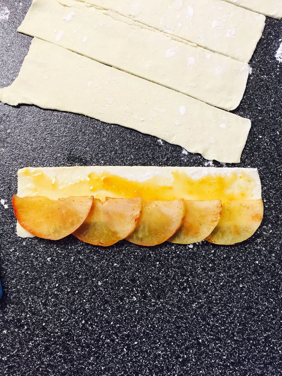 Take your apple slices and place at the edge of the pastry strip