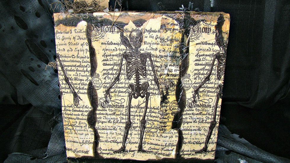Take your Black Leather Jacket paint and smudge all the edges for a finished look and they back of the canvas is done.