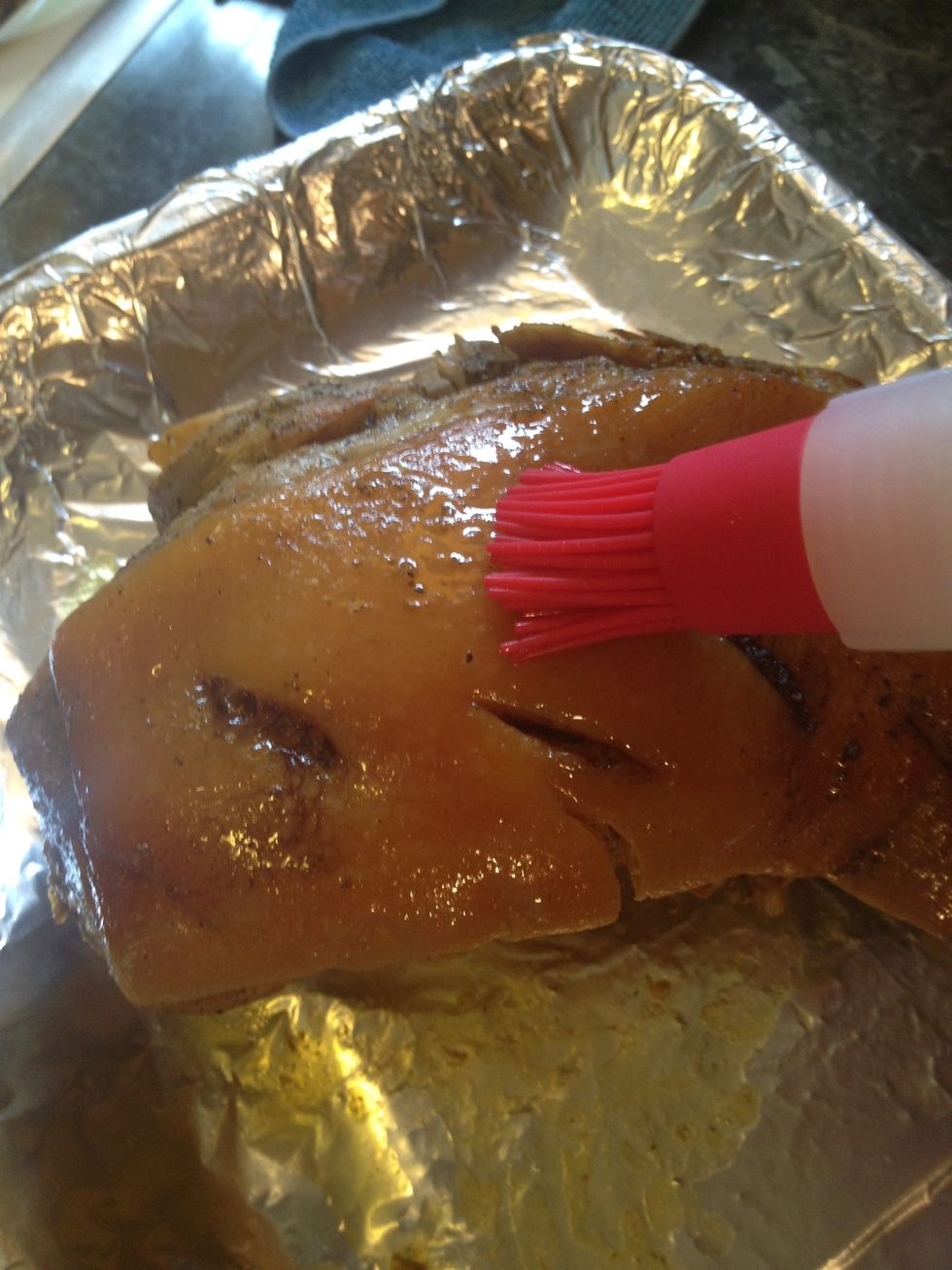 Take your brush and baste the top of the pernil. You might want to detach the skin from the roast so it can cook faster. Before putting it in the 400 deg. oven, cover the sides of the pork with foil.