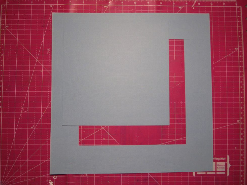 Take your card stock and cut an 8x8 square out of the center. Take your trimmer and move it 2 inches in and then cut down 2 inches. Do this all the way around.
