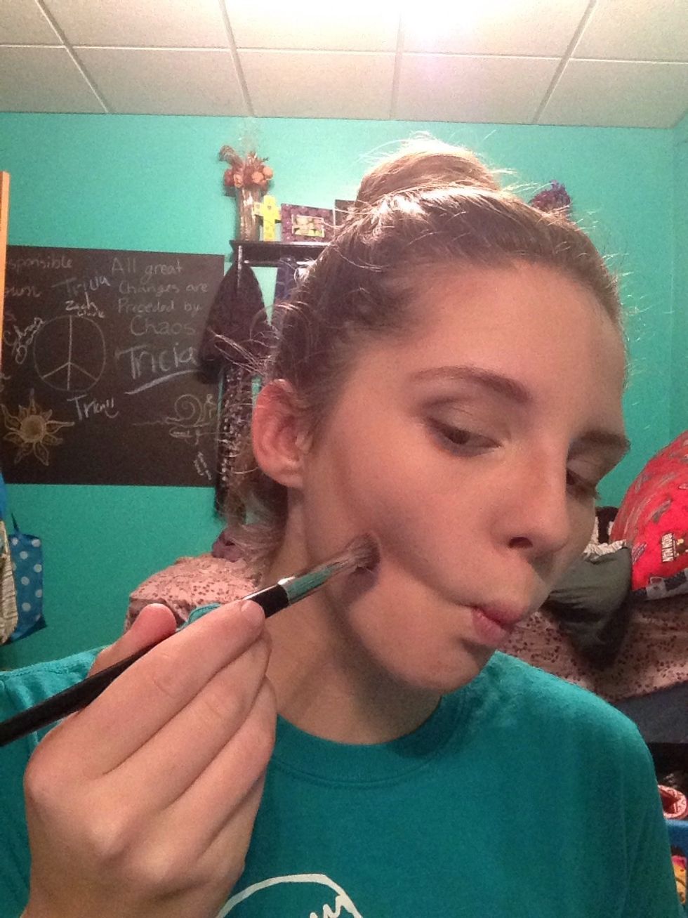 Take your contour brush, lightly coat it in the contour powder. Make a light to medium dark line in the dip of your cheek when you make a fish face.