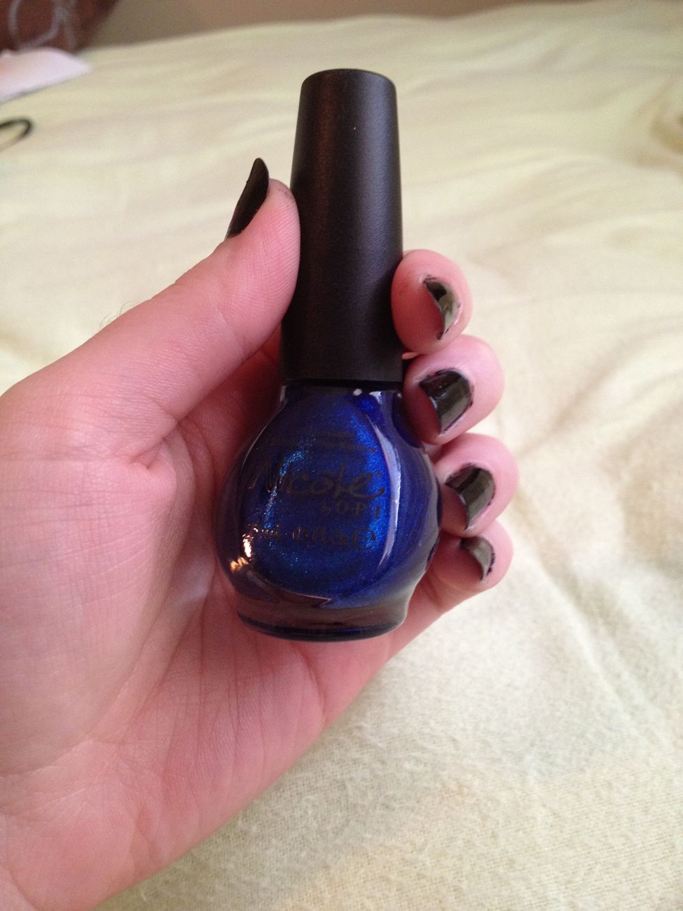 Take your dark blue nail-polish and dab a little bit on the edge of your sponge. Dab the dark blue nail-polish all over each of your nails.