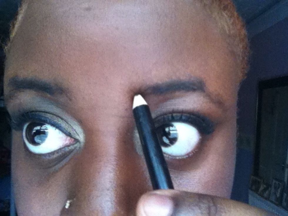 Take your dark eyebrow pencil and define the natural shape of your brow by making an outline