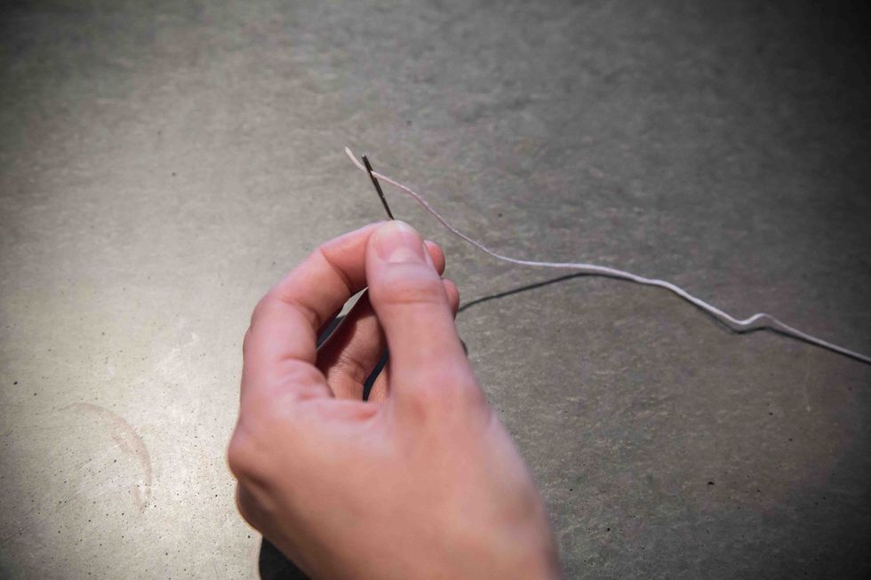 Take your embroidery floss and thread it through the eye of the needle. You may need to trim a fresh end to more easily thread it through.