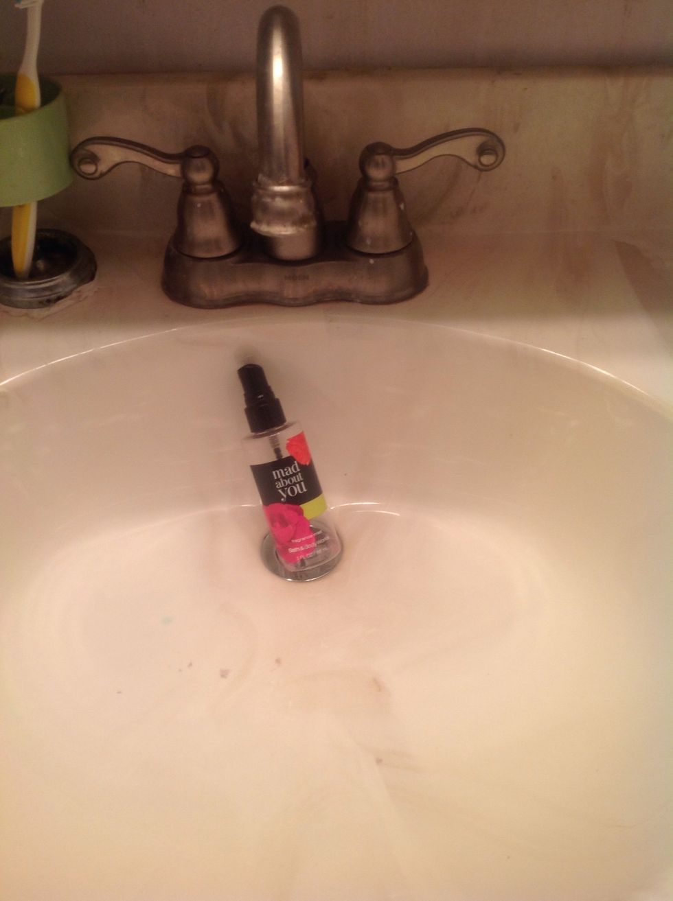 Take your empty perfume bottle to any near by sink.