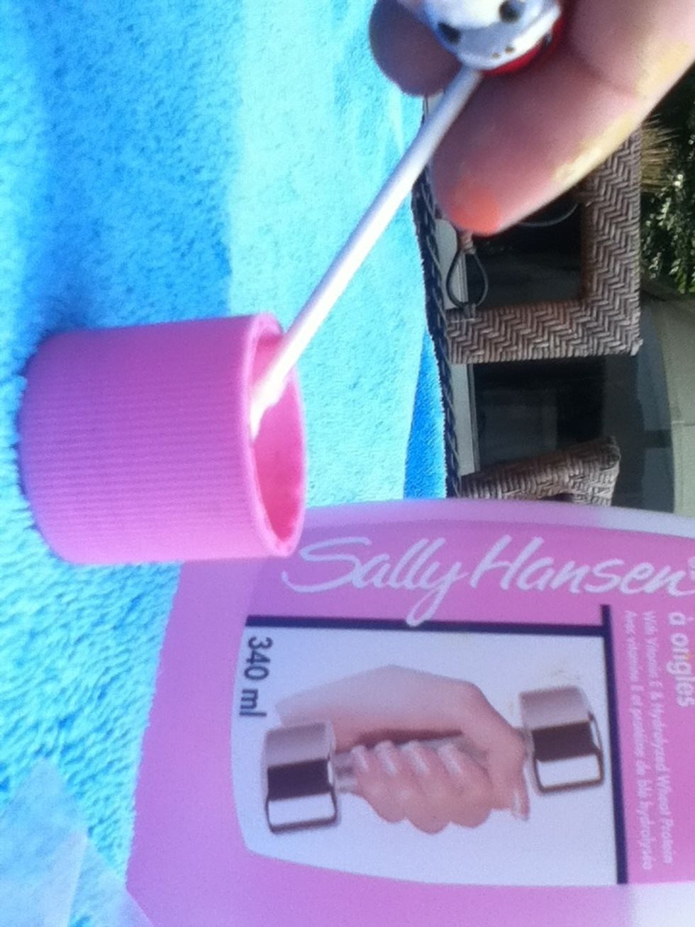Take your favourite nail polish remover and a cotton swab. Pour some remover into the bottle's cap.