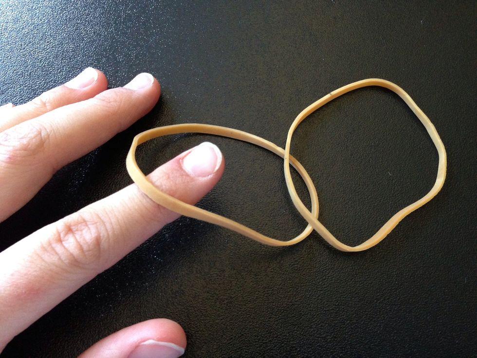 Take your finger and go underneath the rubber band at the bottom.