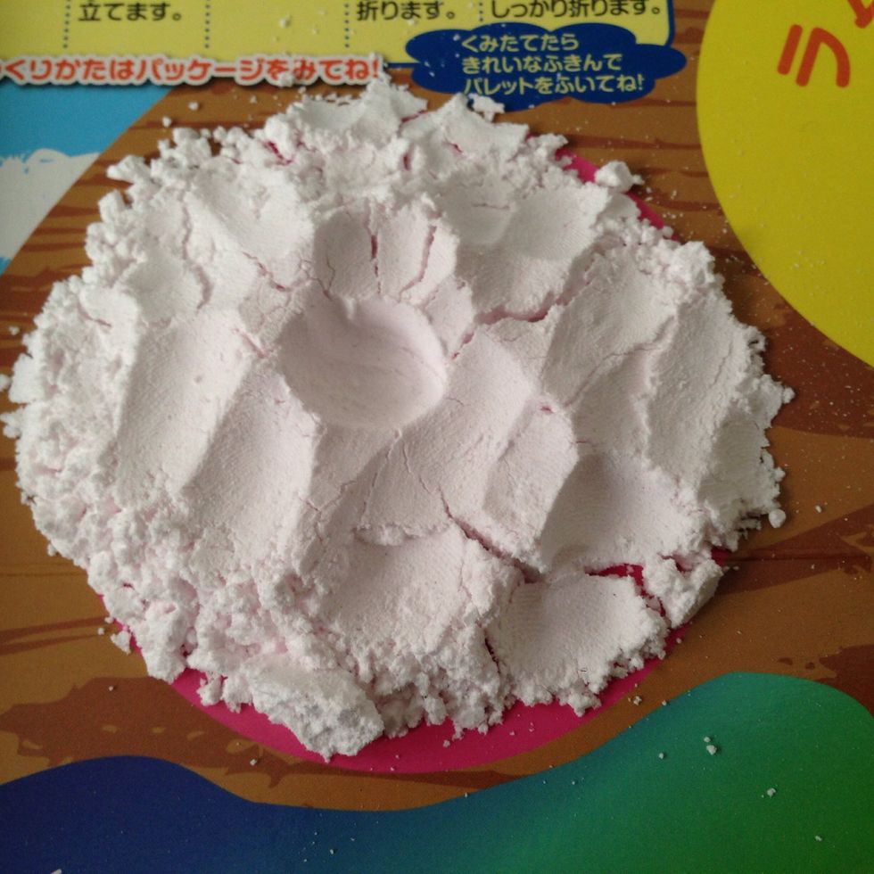 Take your finger and make a little reservoir in the center of the powder