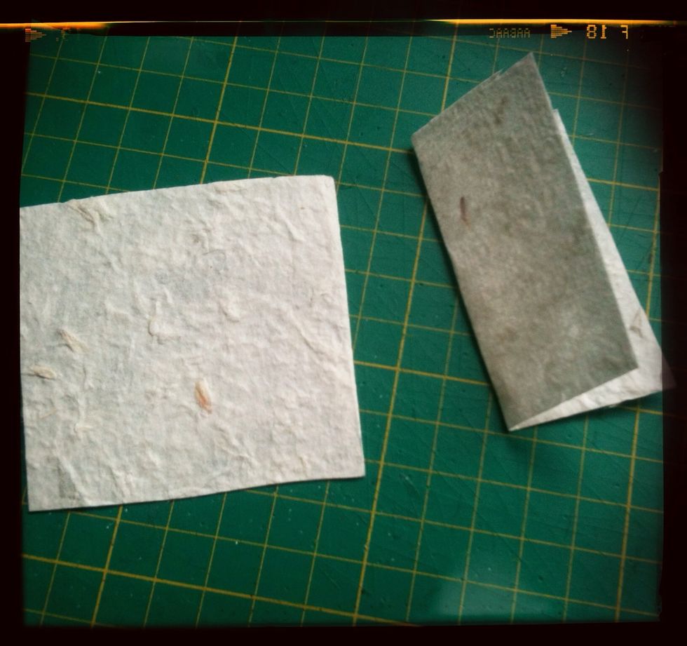 Take your first set of squares (the larger ones), fold them in half down the middle like this.