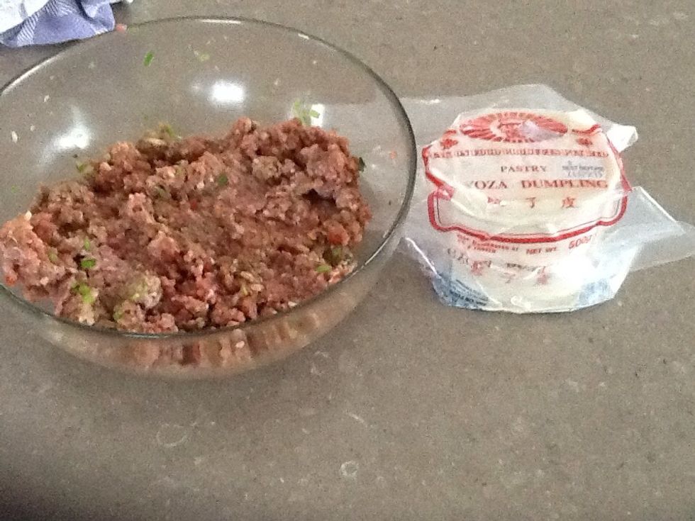 Take your gyoza's wonton wrappers and place a teaspoon of the pork mince and place in the centre of the gyoza wrapper