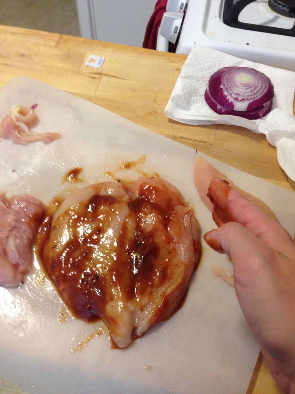 Take your hands or a brush and cover the chicken breast.