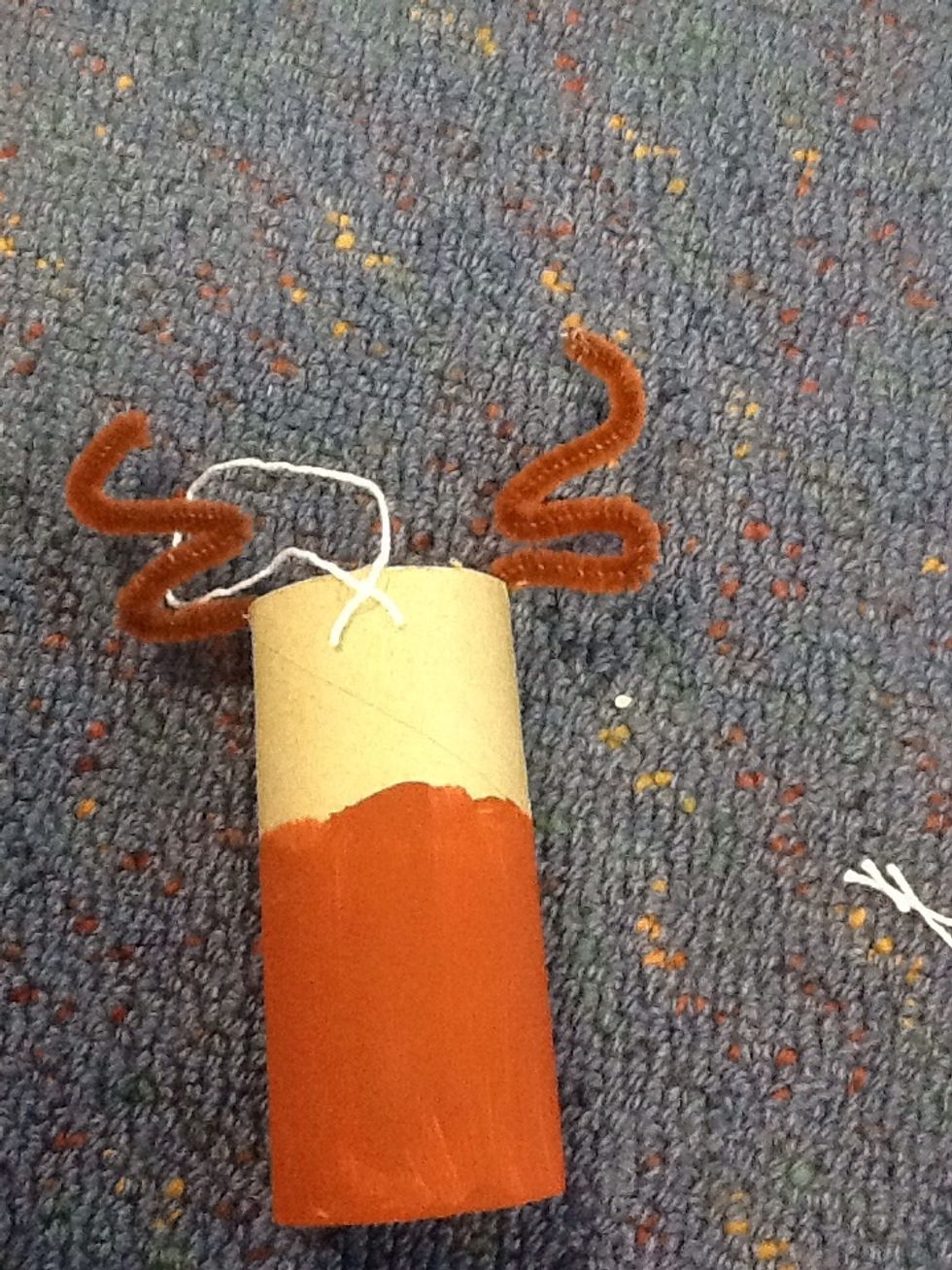 Take your hot glue gun and do a little spot of glue and carefully place the knotted string on if you want use scissors to push the string further into the glue which will make it stick better.