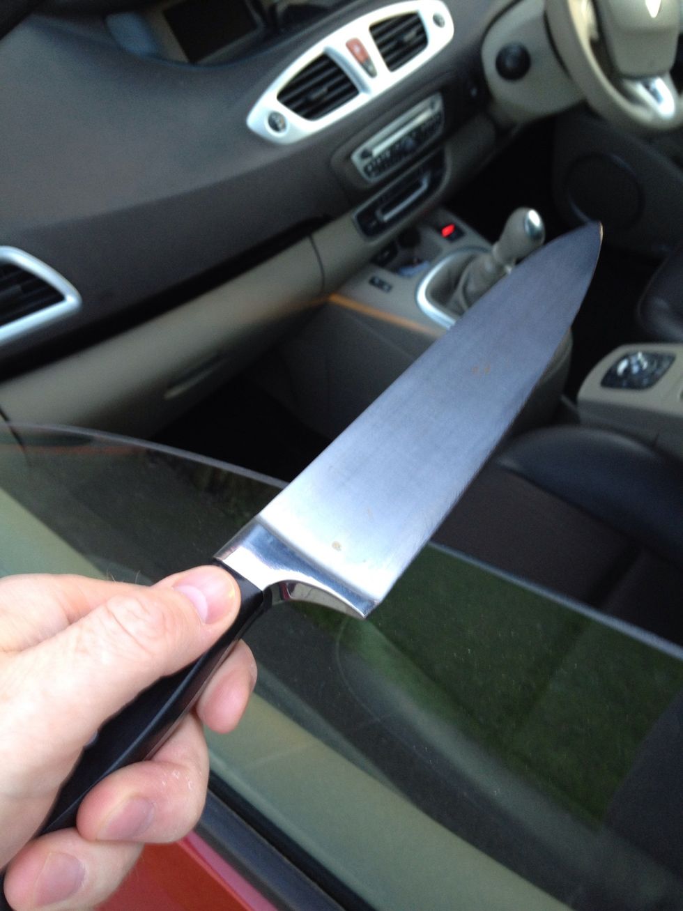 Take your knife to your car and wind your window half way down, then draw one side of the blade across the edge of your window towards you, about three times.. NEVER AWAY FROM YOU.