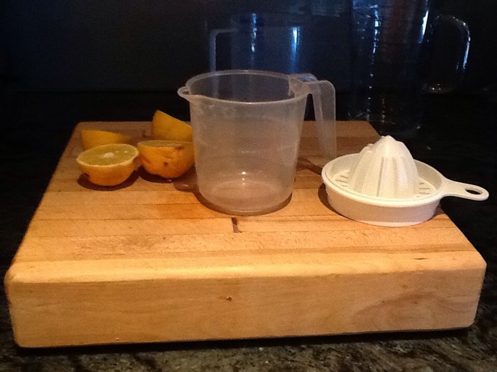 Take your lemon squeezer and the small jug. Then squeeze the lemons into the small jug and trough the lemon squeezer.