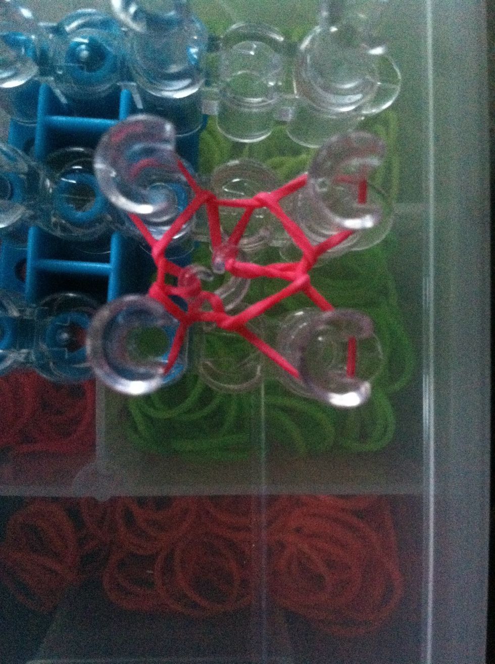 Take your loom tool and loop the bottom band over the top band