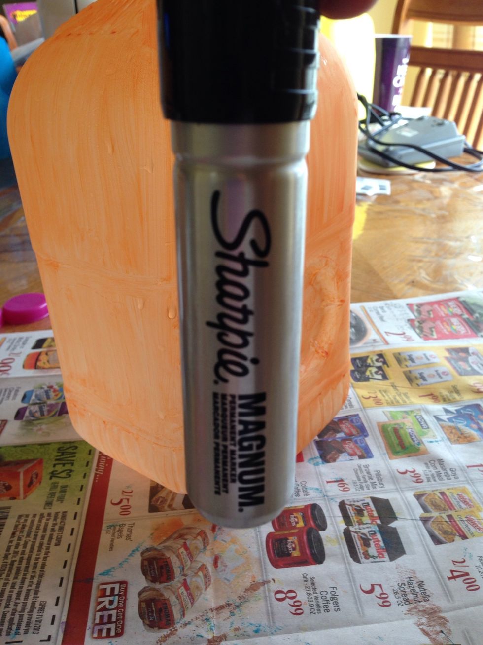 Take your marker and draw an outline for the face that you want.