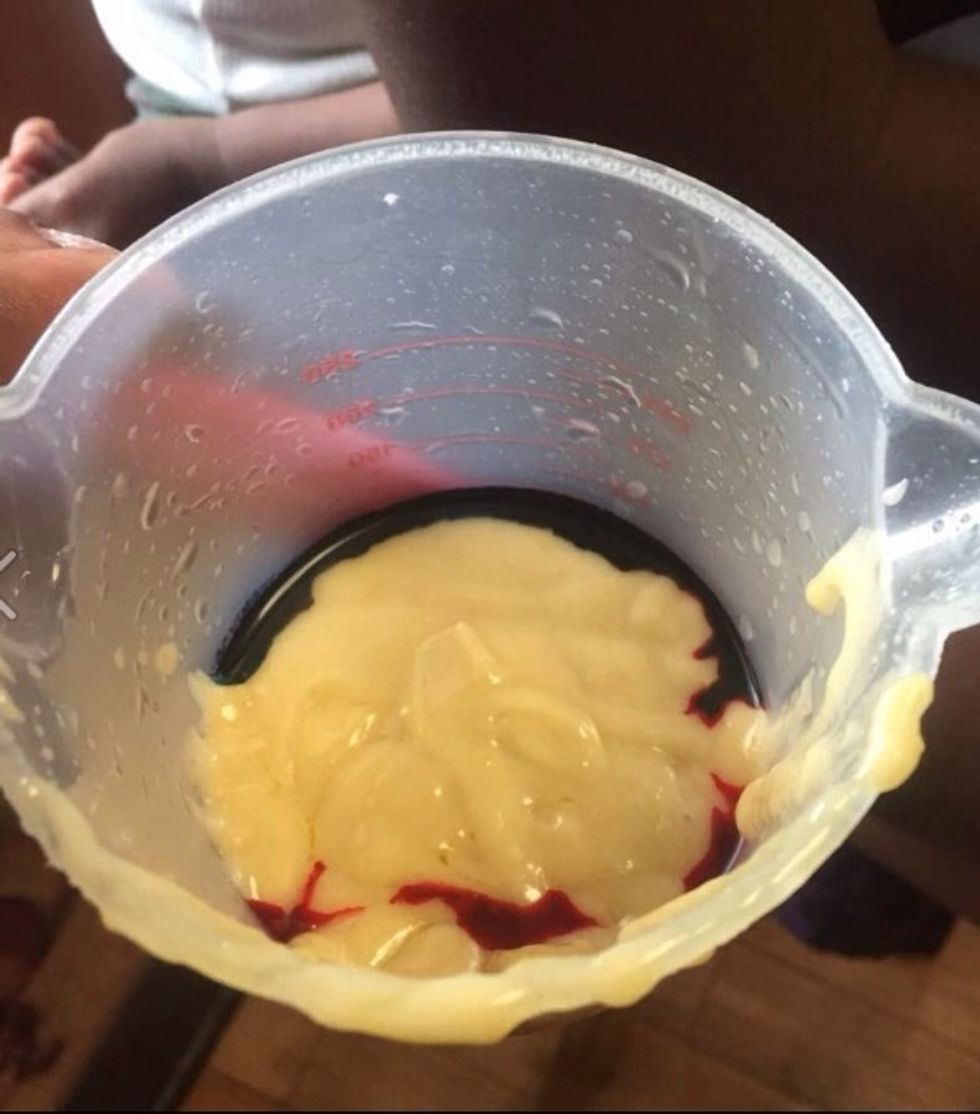 Take your measuring cup and add your food coloring to the bottom of it and stir. Pour up to about 1/3 of the way . Do this for all of your colors.