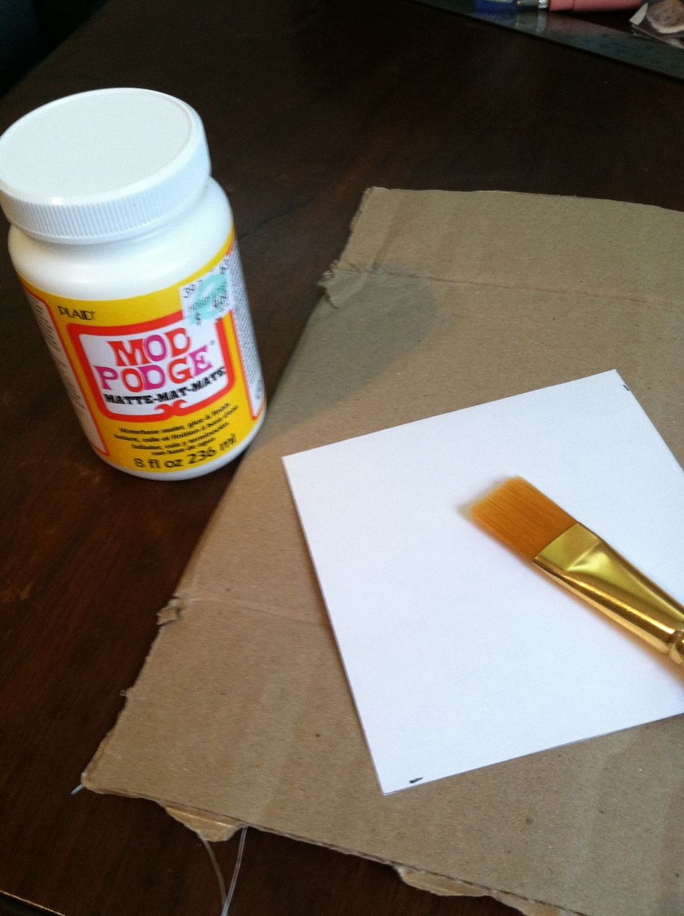 Take your paintbrush and apply Modge Podge liberally to the back of the paper....