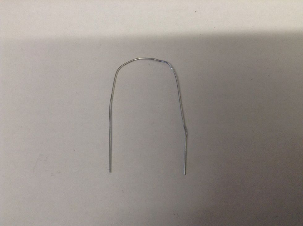 Take your paper clip and bend it into a loose U shape.  If it is plastic coated remove about 1 inch of the coating from each end to expose the wire.