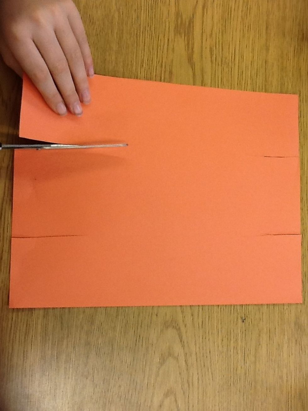 Take your paper,there should be four sides.take two of the smallest sides and put two cuts in each of the sides.