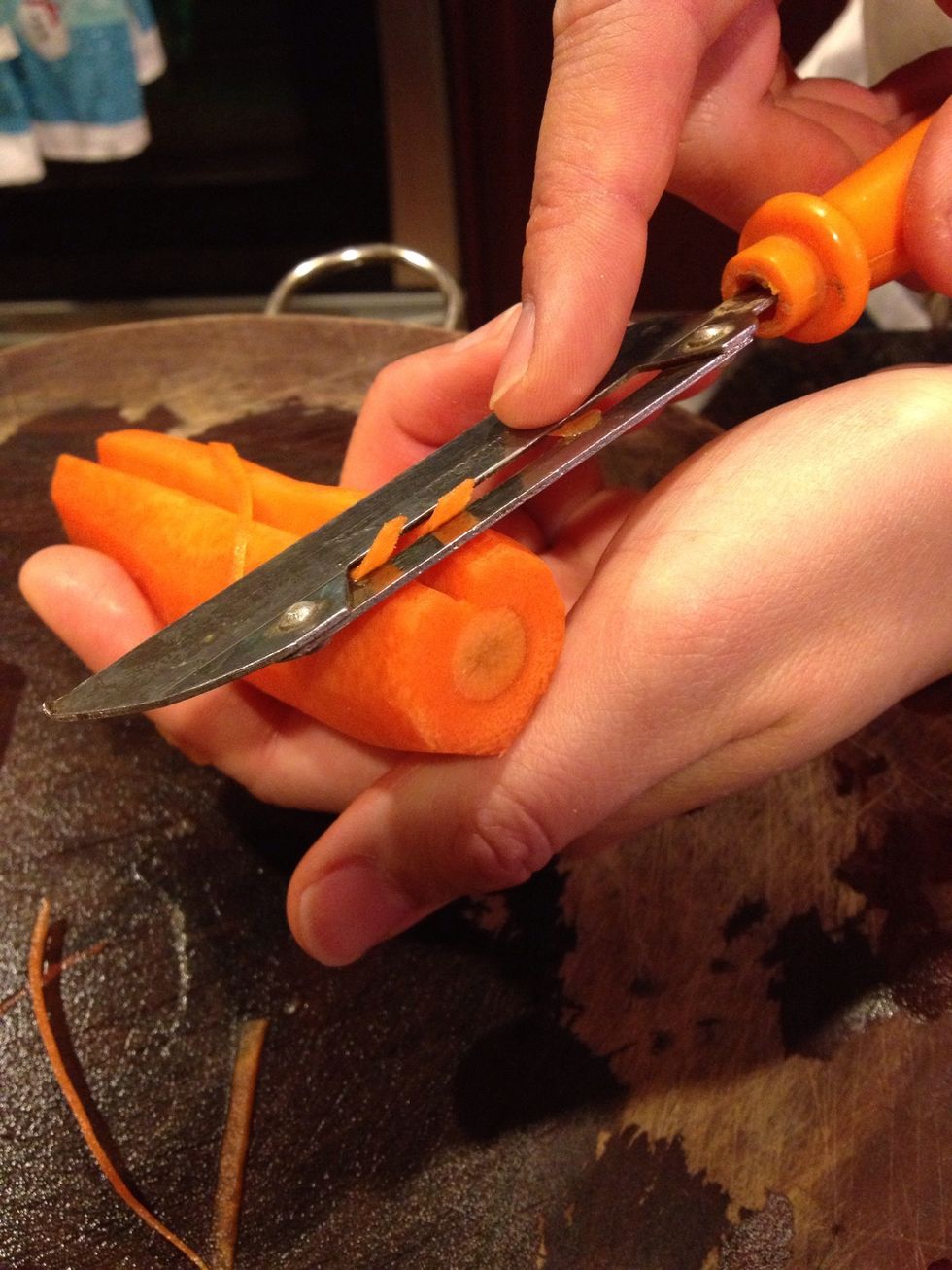 Take your peeler & peel off the top of where you cut into the carrot. The purpose of doing this is to round off the edges as this will be the top of your heart.