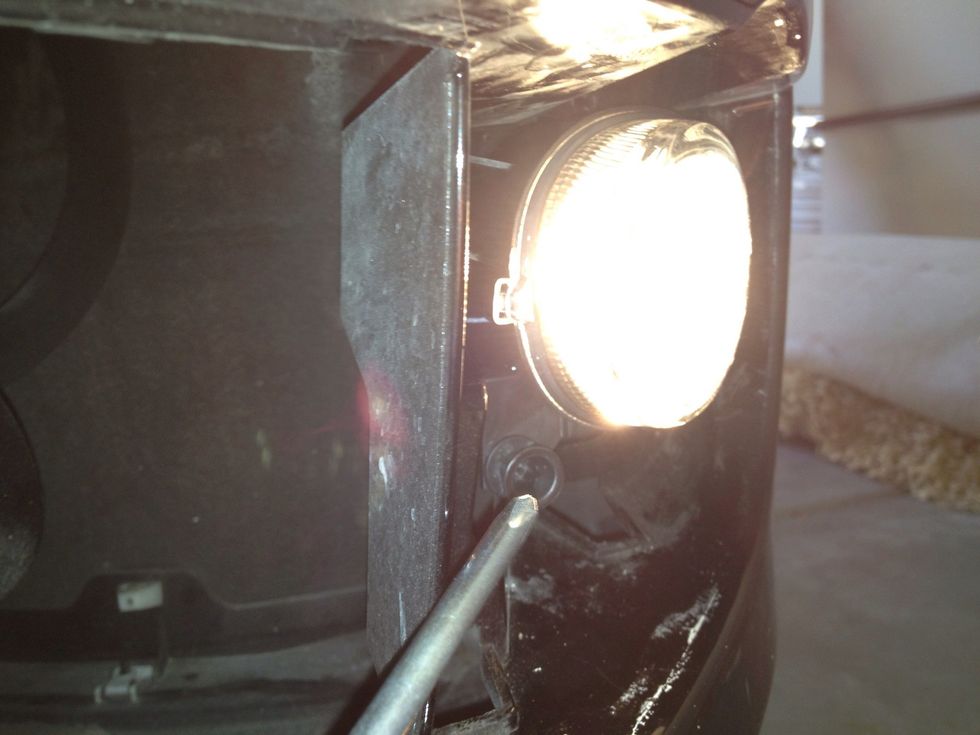 Take your Phillips screwdriver and stick into bottom left Phillips screw. Turn clockwise or counterclockwise depending on if your fog light needs to be adjusted up or down.