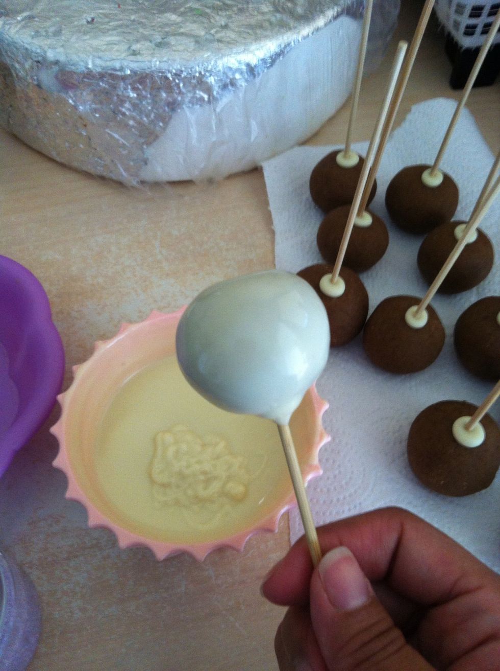 Take your pops out of the fridge and dip them one by one into melted chocolate.