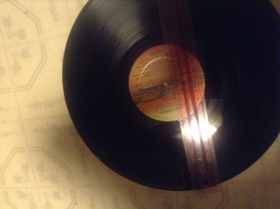 Take your record and your ruler and make four 1 1/2" marks where 12,3,6, and 9 will go with the colored pencil.