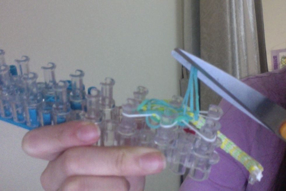 Take your scissors and cut the blue bands, like so,