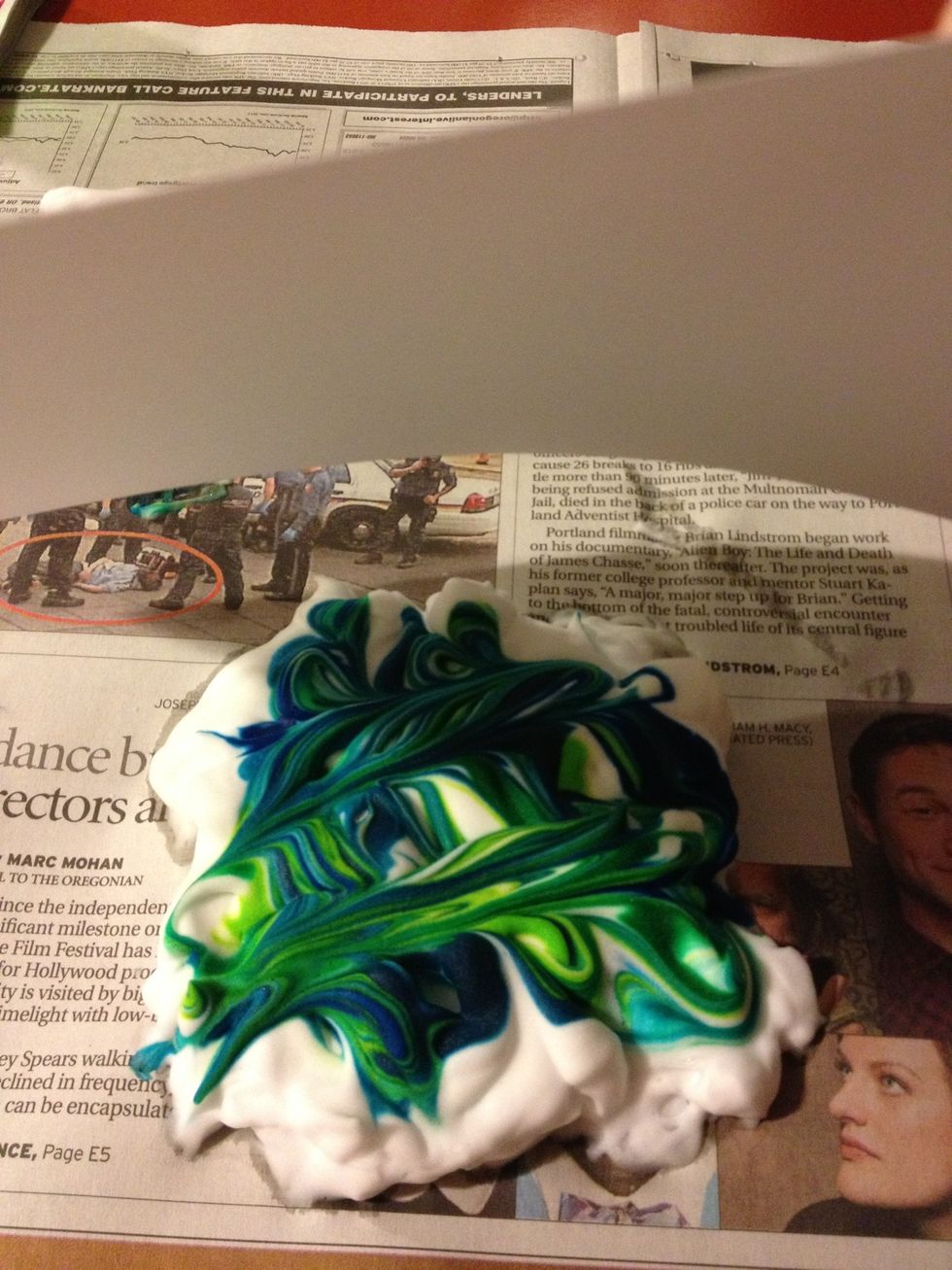 Take your sheet of paper and place it on the colored shaving cream!