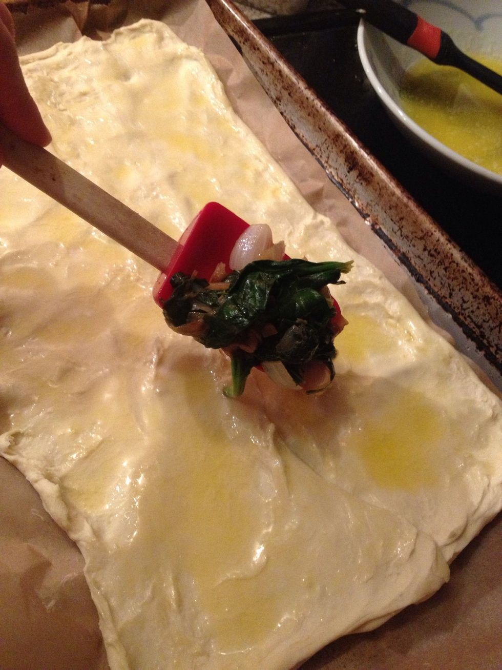 Take your spinach and other stuff from the pan and spoon it onto the pastry sheet.