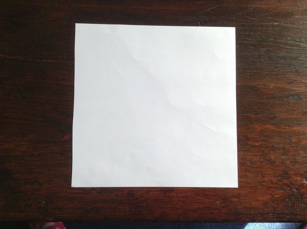 Take your square of paper and place it on a flat surface. E.g. A table.