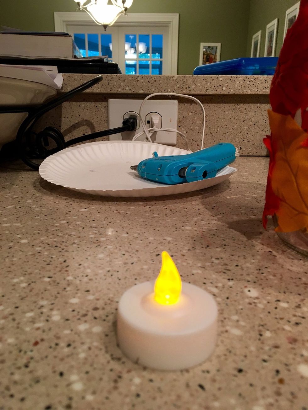 Take your tea light and turn it on. If you are using a real candle, place the candle into the jar first before lighting it. You may want to tape the candle down so it does not move in the jar.