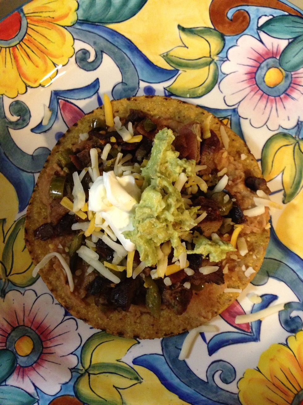 Take your tostada shell or taco shell and add beans, meat, cheese, sour cream, and guacamole. Serve with a side of rice or you can also add the rice to the tostada/taco. 1 of my husbands faves! ENJOY!