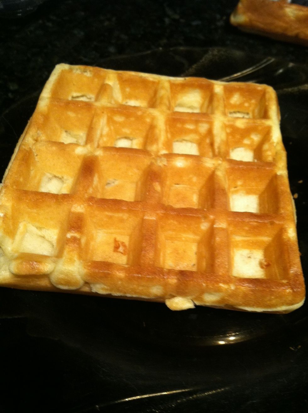 Take your waffle out of the toaster and put it on a plate.