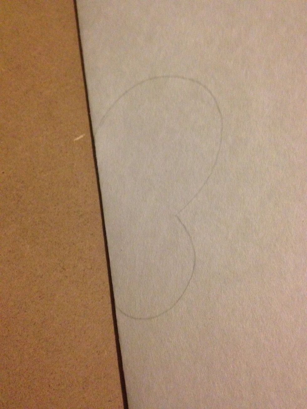 Take your white paper and fold in half. Draw this shape on the folded edge.