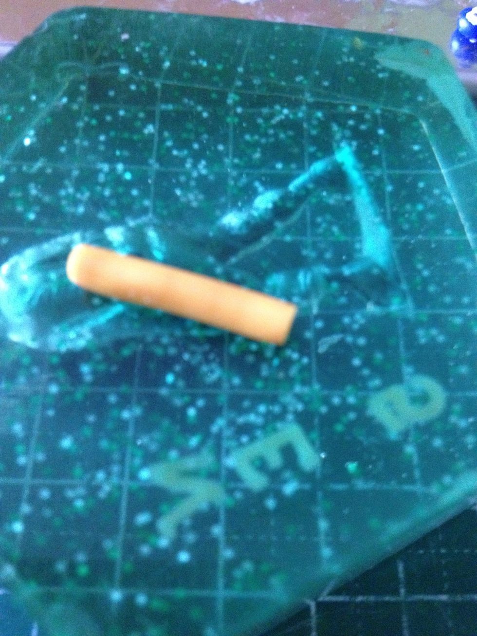 Take your yellow clay and roll it out into a snake. This is going to be the egg 'yolk'.