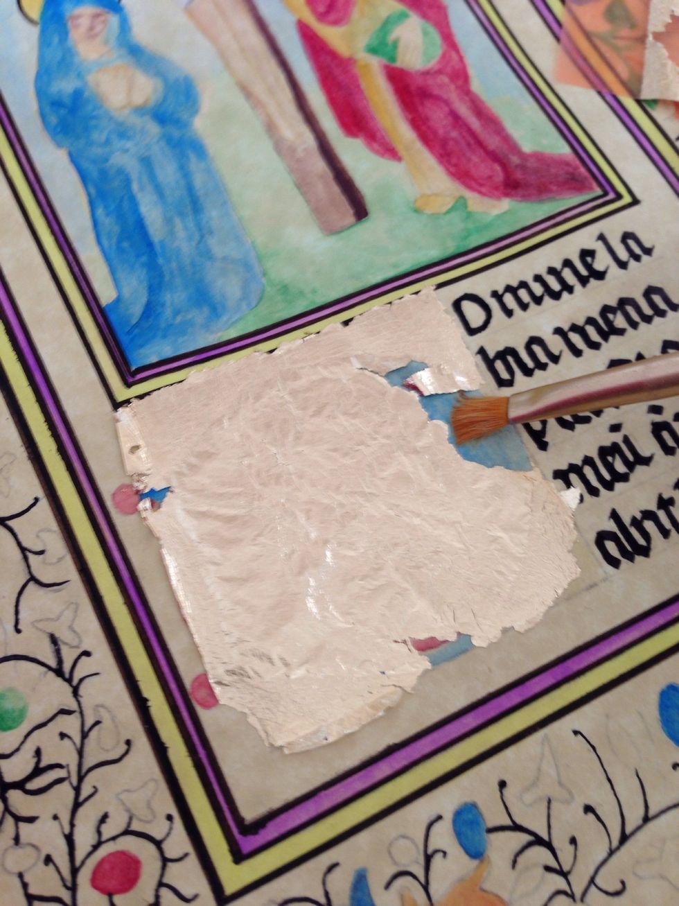 Taking a brush start brushing over the area to get the excess gold off