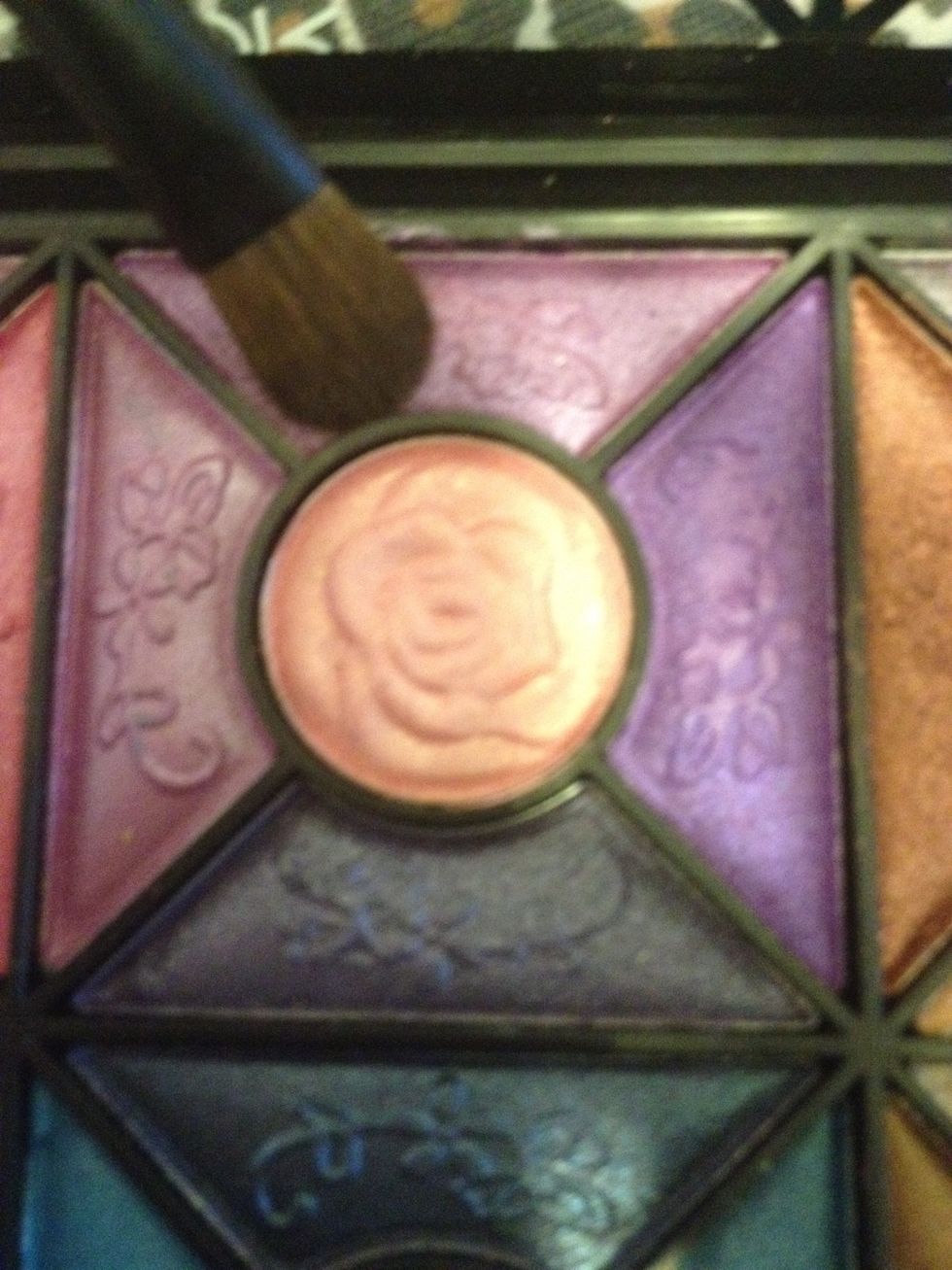 Taking a lighter purple eyeshadow, using the flat shader brush