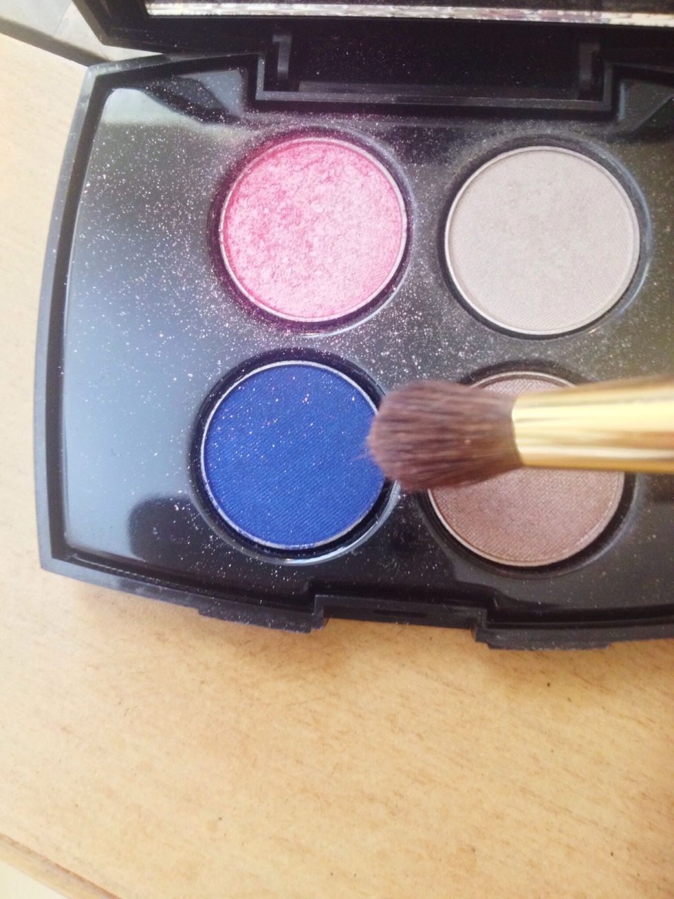 Taking a small blending brush pick up a blue matte shade and blend into the outer v and crease