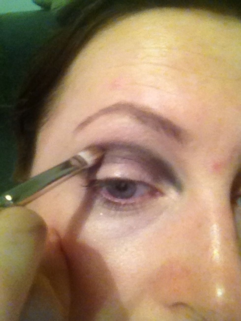 Taking my mac contour brush I'm placing the colour to lids and bringing to a point close to tear duct