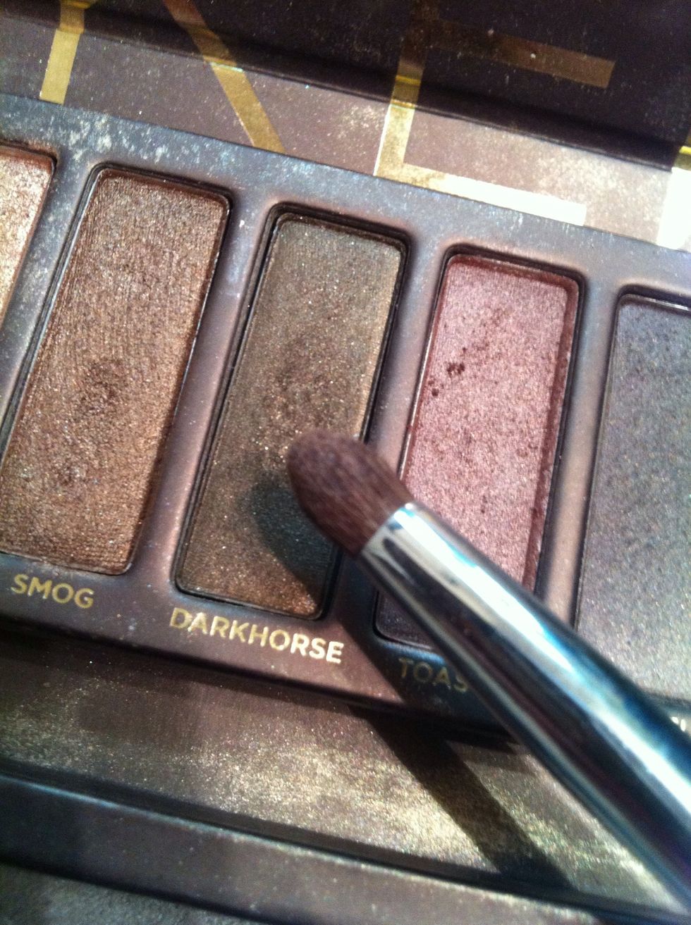 Taking the color darkhorse or a medium/dark brown apply it to the outer crease of your eye.