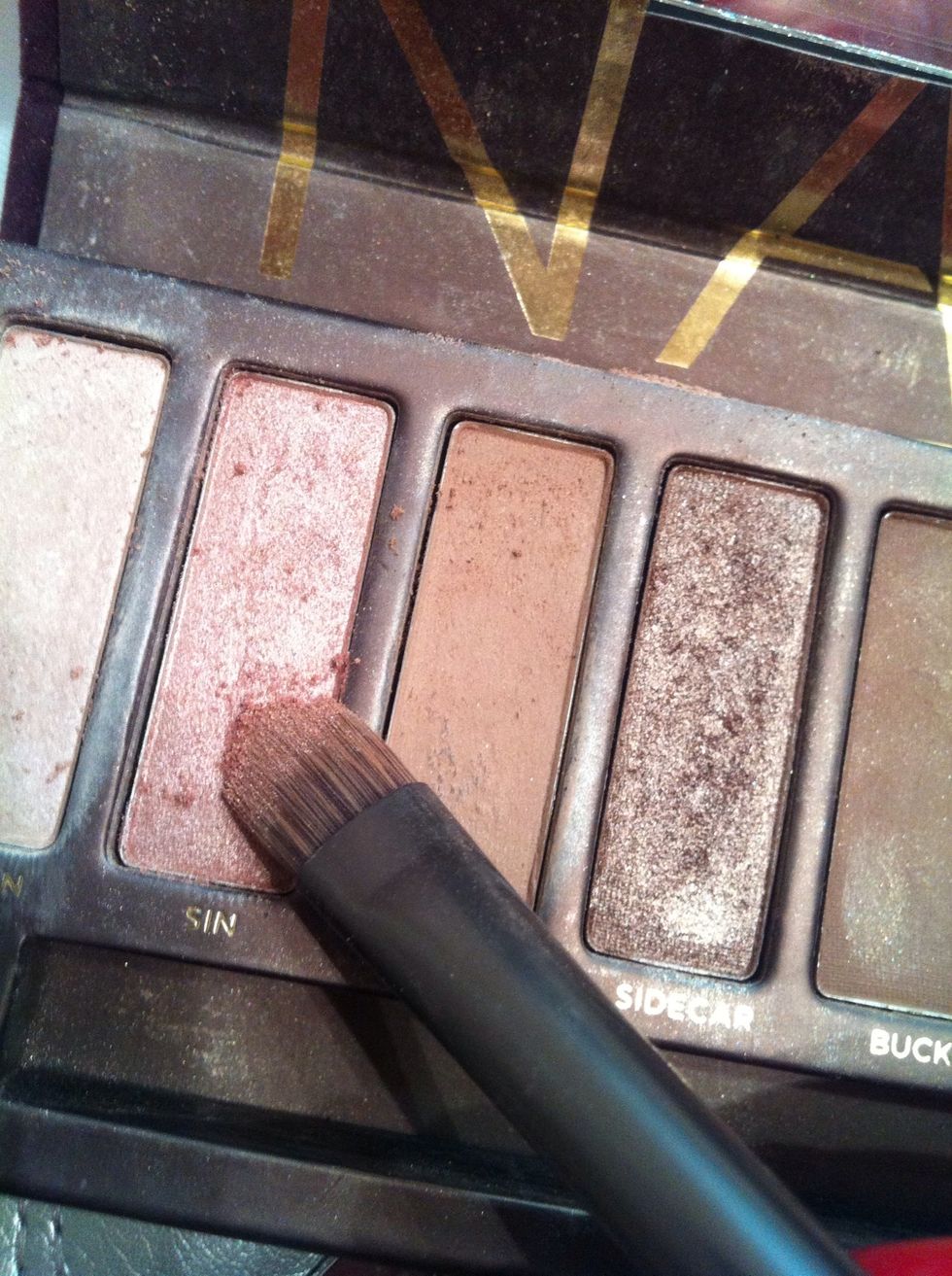 Taking the color sin or any other light rosey color apply it in a straight line where your eyeliner normally is. (Messy is okay we will blend it all later)