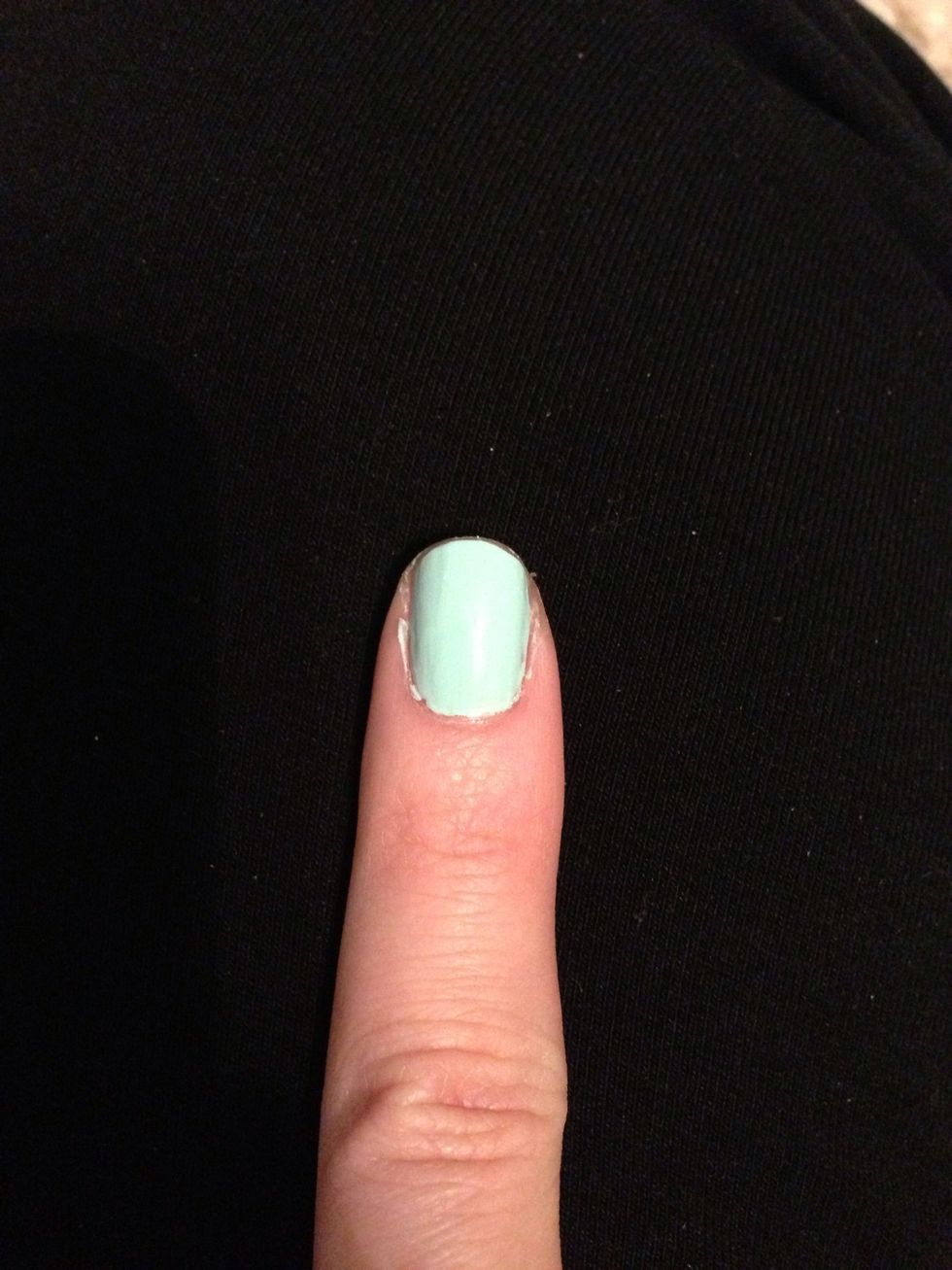 Taking your lightest color, paint your nails over a base coat