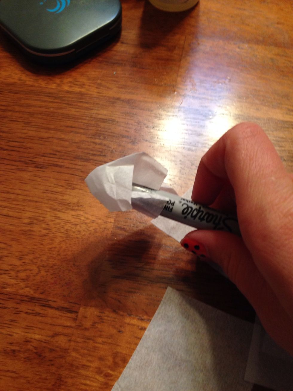 Taking your marker, scrunch the cut paper around the bottom of your marker, pen, or pencil.