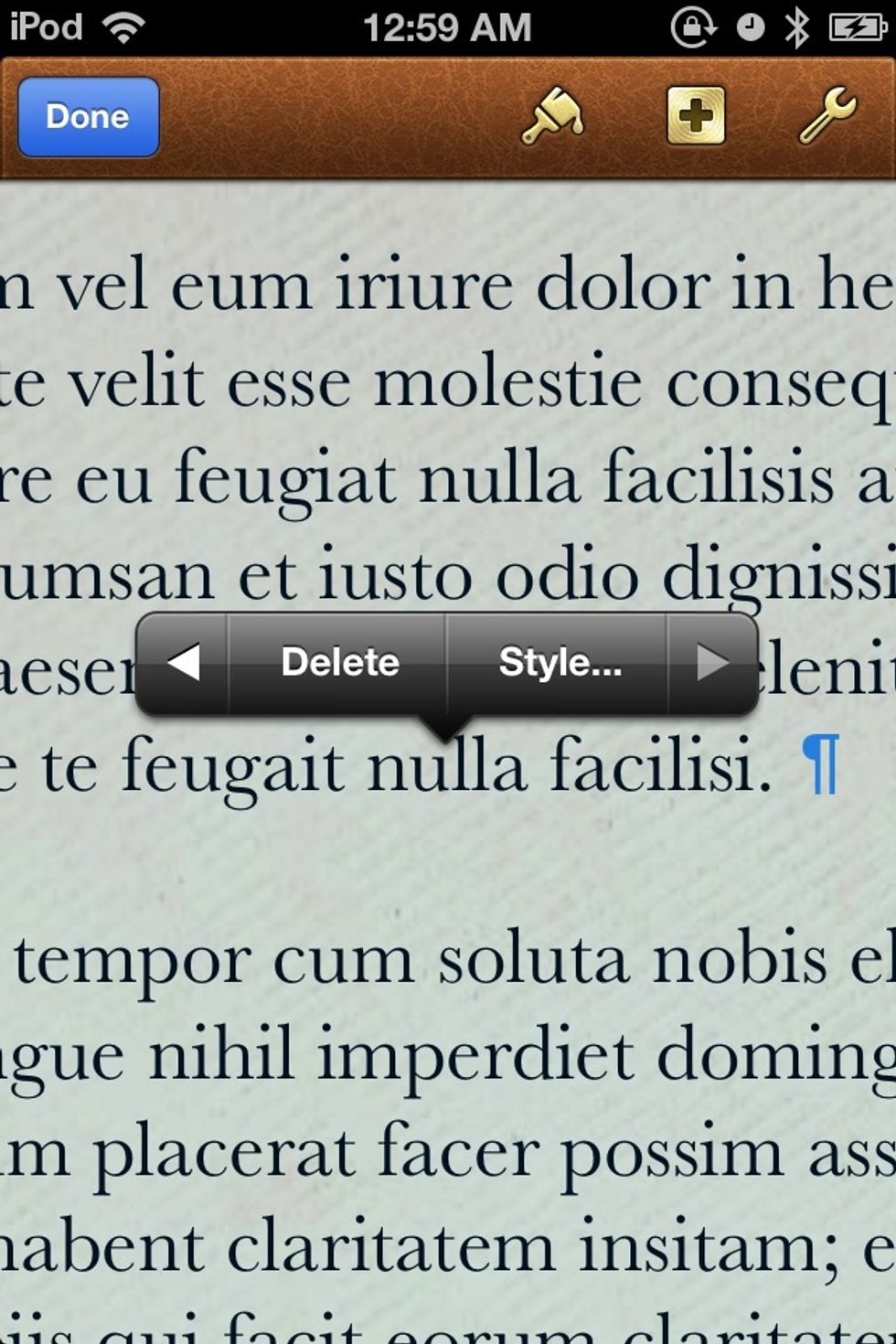 Tap and hold somewhere in your text to bring up a menu. You might have to tap the white arrow on the menu to get the the DELETE option. Tap DELETE.