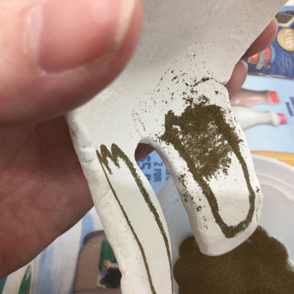 Tap off excess embossing powder.